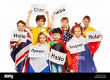 Kids holding greeting signs in different languages Stock Photo - Alamy
