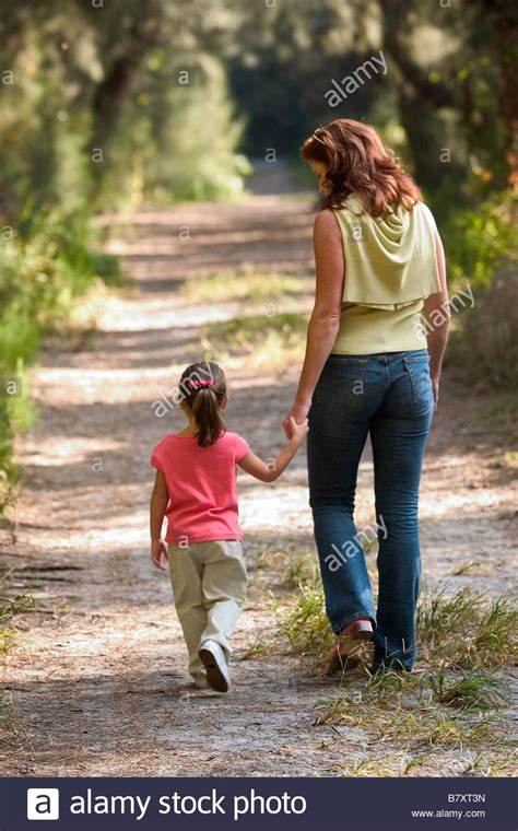 Mother And Child Walking In Park On Trail Stock Photo Alamy
