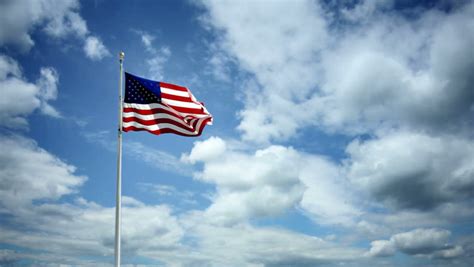 American Flag Waving Against A Beautiful Cloudy Sky Stock Footage Video