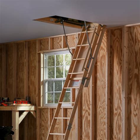 werner w 7 ft to 8 75 ft rough opening 25 in x 54 in folding wood attic ladder with 250 lbs