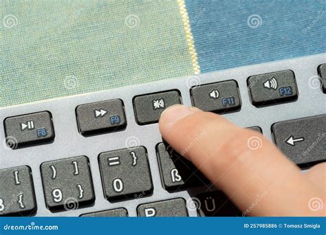 Anonymous Man Pressing The Mute Button Sound Off Key On A Modern
