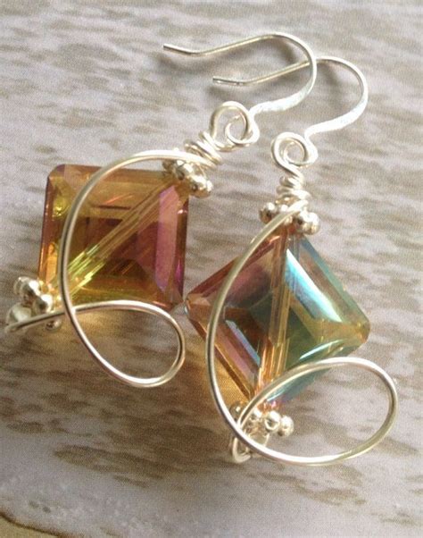 The Earrings Are Made Out Of Wire And Have Multicolored Glass Beads On Them