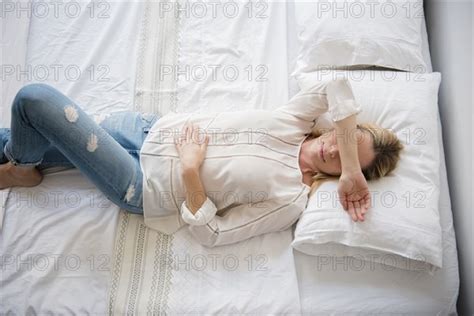 Caucasian Woman Laying On Bed Covering Eyes Photo12 Tetra Images Jgi Jamie Grill