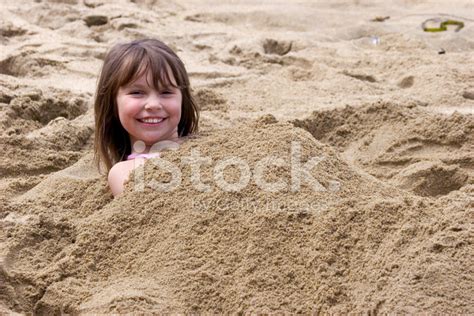 Girl Buried In Sand Stock Photos