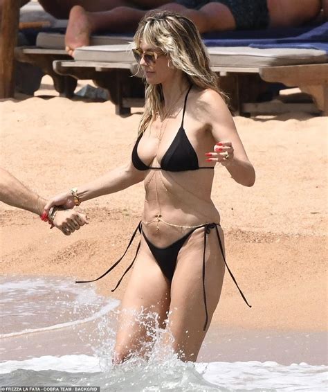 heidi klum 50 proves age is just a number as she stuns in a string bikini while kissing
