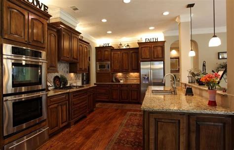 Kitchens with cherry wood cabinets offer a warm and luxurious look and match well with a variety of different countertop materials and finishes. Cherry Kitchen Cabinets with Dark Wood Floors | Hardwood ...