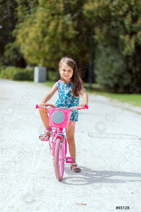 Young Girl Riding A Bike Stock Photo Crushpixel