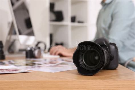 Professional Photographer Working At Table In Office Stock Image