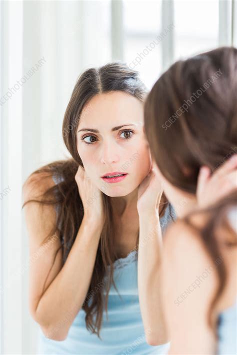 Woman Checking Her Face In The Mirror Stock Image C0352100 Science Photo Library