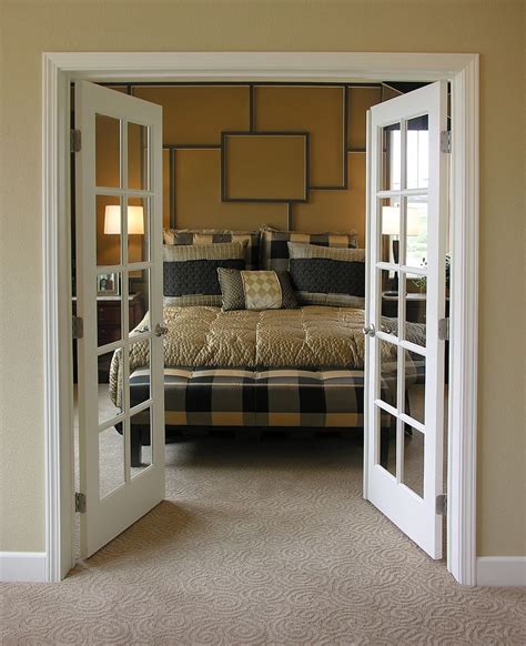 An Open Door Leading To A Bedroom With A Bed In The Middle And Two
