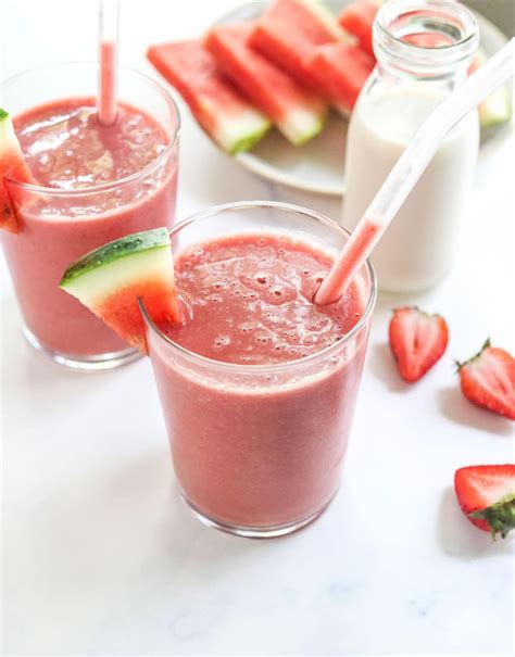 Two Glasses Filled With Watermelon And Cucumber Smoothie Next To Sliced