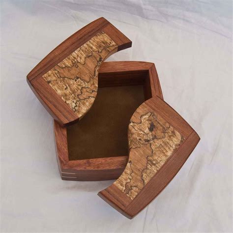 Four Examples Of A Handmade Decorative Keepsake Box With The Lids Open