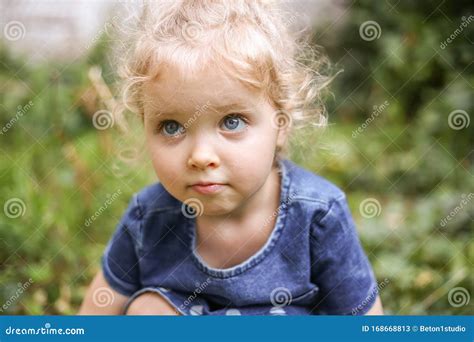 Girl With Curly Blonde Hair And Blue Eyes