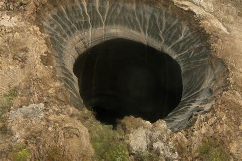 A Large Hole In The Side Of A Mountain With Water Coming Out From Inside It