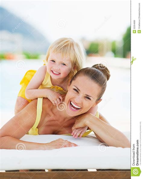 Portrait Of Happy Mother And Baby At Poolside Royalty Free