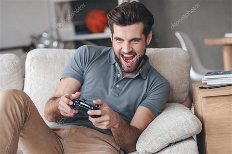 Handsome Man Playing Video Game Stock Photo By ©gstockstudio 100200786