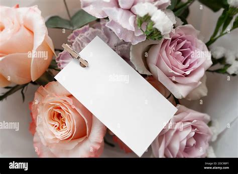 White Greeting Card On Decorative Clothespin In Bouquet Of Delicate
