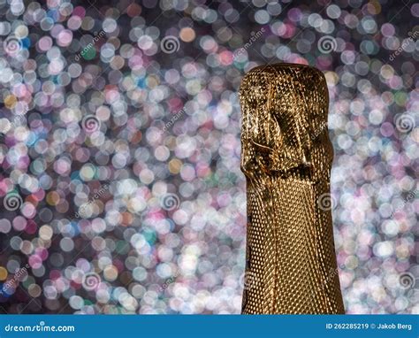 Bottle Of Champagne With Gold Glitter On A Shiny Background Stock