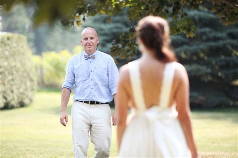 A Man In A Blue Shirt And White Dress Walking Towards A Woman
