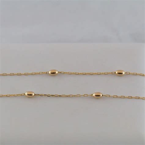 Adorned with five polished, 14k gold beads arranged in a graduated pattern, this everlasting gold necklace is sure to brighten your look. 14K Gold Bead Station Necklace 20 Inches : Ann-tiques and Fine Jewelry | Ruby Lane