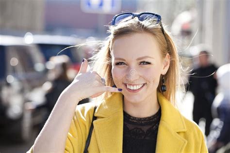Beautiful Happy Blonde Woman Making A Call Me Gesture Stock Image