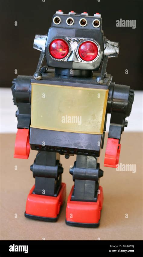 Retro Toy Walking Plastic Robot With Grey Body Big Red Eyes And Red