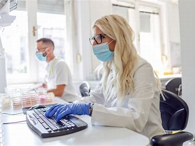 Premium Photo | Attractive blond lab assistant sitting in laboratory ...