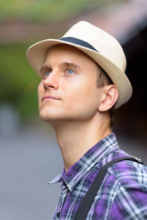 Face Of Young Handsome Tourist Man Thinking And Looking Up Stock Photo