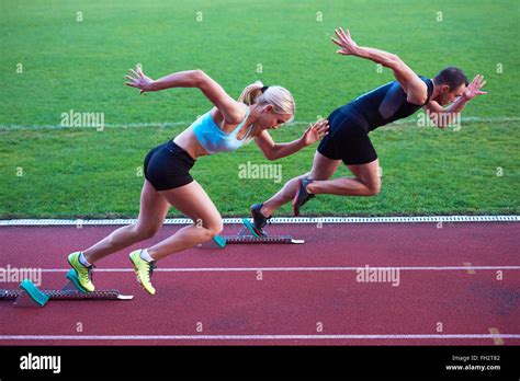 Woman Group Running On Athletics Race Track From Start Stock Photo Alamy