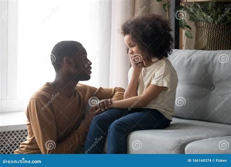 Supportive Black Dad Talk Cheering Sad Preschooler Daughter Stock Photo