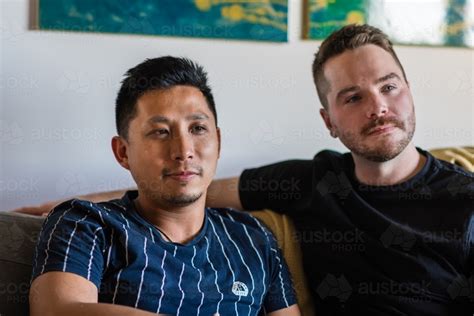 Image Of Gay Male Couple Sitting On Couch Austockphoto
