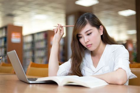 Asian Beautiful Female Student Study In Library With Laptop China