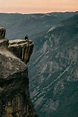 Man Standing At The Edge Of A Mountain Cliff In Yosemite | Stocksy United