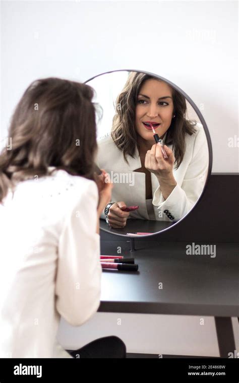 Woman At Home Is Putting Her Lipstick On Stock Photo Alamy
