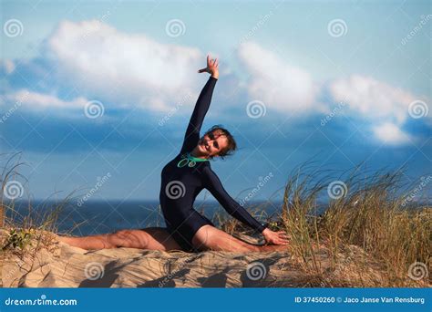 Acrobatic Gymnast Is Arching Her Back On The Beach Stock Image 37450189