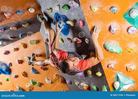 Young Man Bouldering In Indoor Climbing Gym Stock Image Image Of