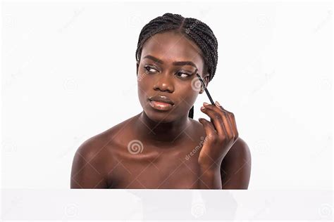 Beauty Portrait Of A Smiling Beautiful Half Naked African Woman Applying Make Up With A Brush
