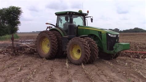 A John Deere 8245r Tractor Applying Manure Following The 2015 Silage Corn Harvest With A Manure