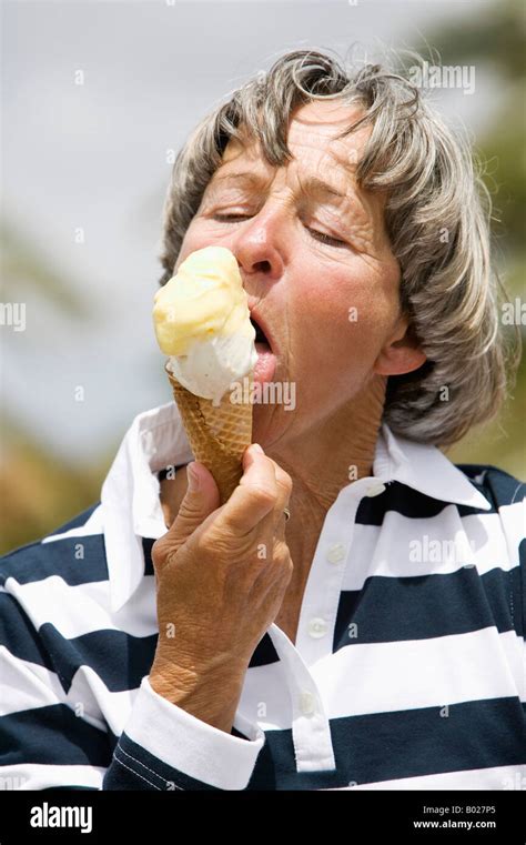 Headshot Of Mature Woman Licking Ice Cream Stock Photo Alamy