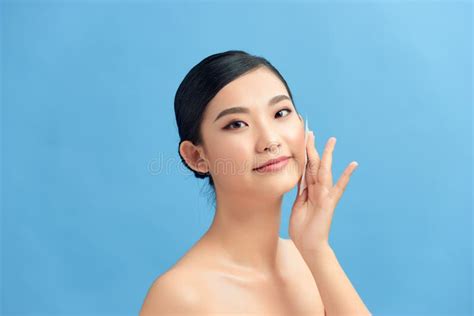 Closeup Of Beautiful Happy Asian Girl Model With Natural Makeup Using Oil Absorbing Sheets