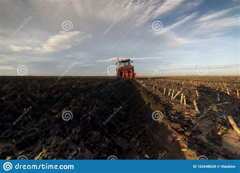 Tractor Plowing Preparing The Soil For Sowing In The Fall Stock Photo