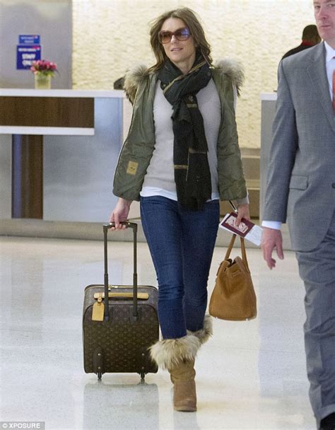 Liz Hurley Wears Fur Trimmed Gilet And Boots As She Arrives At Jfk