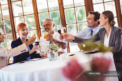 Group Of Business People Toasting Wine Glass In Restaurant