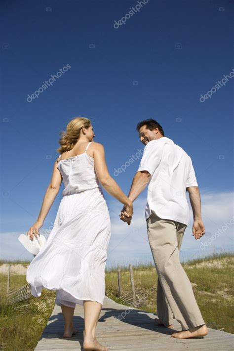 Couple Holding Hands Walking Down Path — Stock Photo © Iofoto 9498051