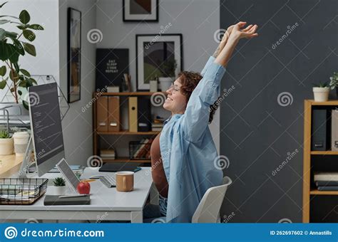 Woman Doing Stretching Exercises At Her Workplace Stock Photo Image