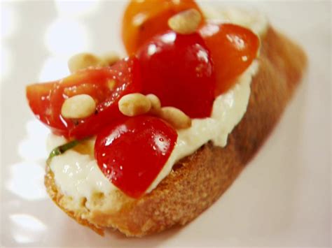 To assemble the crostini, spread each slice of bread with a generous amount of whipped feta. Tomato Crostini with Whipped Feta | Recipe | Cream cheeses, Feta and Barefoot