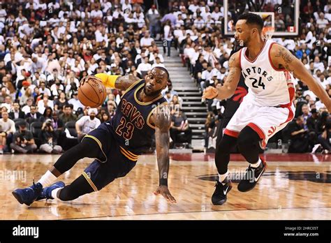 Cleveland Cavaliers Forward Lebron James 23 Slips On The Floor As Toronto Raptors Guard Norman