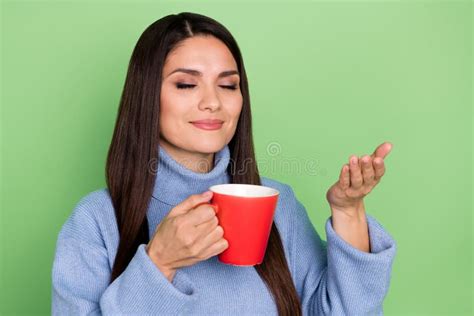 Photo Of Nice Mature Brunette Lady Drink Tea Wear Blue Pullover Isolated On Green Color