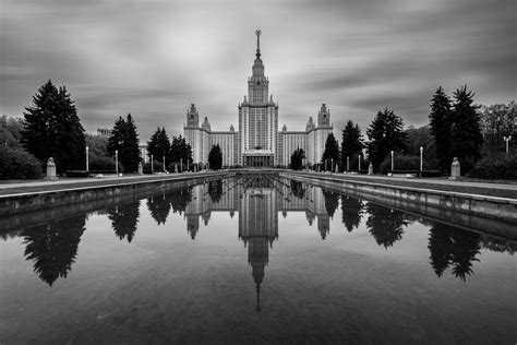 A Very Tall Building With A Clock Tower In The Middle Of It Photo