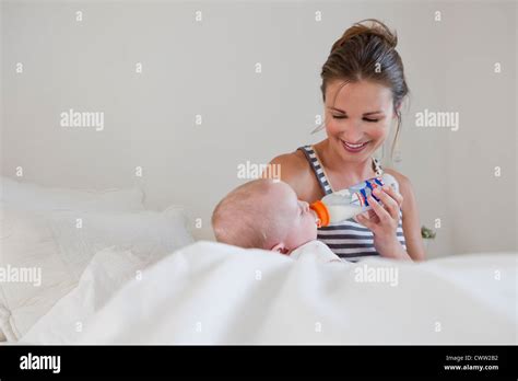 Smiling Mother Bottle Feeding Baby Stock Photo Alamy